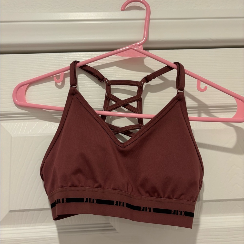 Looks brown on camera but is a pinky cross back sports bra, & adjustable straps!